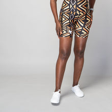 Load image into Gallery viewer, High-waisted biker shorts with a geometric pattern in black, brown, orange, and white colors, featuring two side pockets.